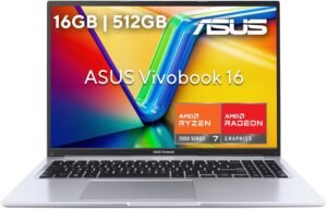 Vista frontal de la laptop ASUS Vivobook 16 M1605YA abierta, destacando su teclado con sección numérica y los logotipos de AMD Ryzen y Radeon en el chasis.