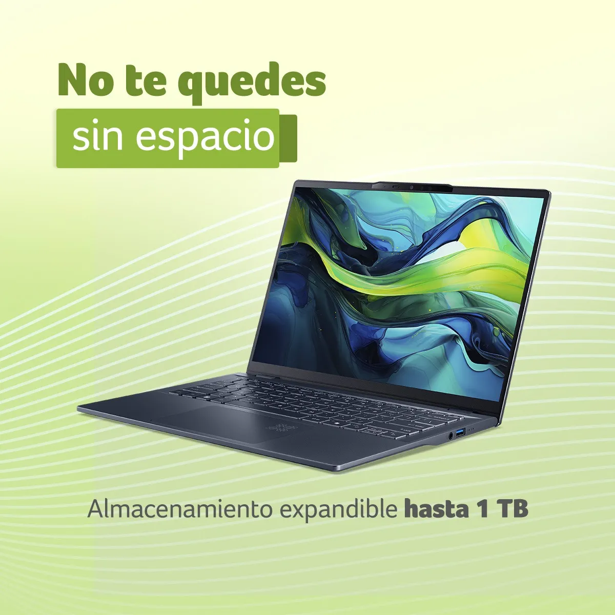 Laptop con almacenamiento expandible Laptop gris abierta sobre fondo verde con texto sobre capacidad de almacenamiento de 1TB.